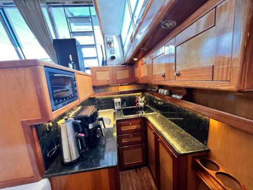 a kitchen with wooden cabinets and a counter top at Exclusive 2 in Cesme