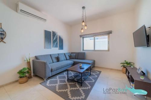 a living room with a blue couch and a table at Brand New Townhome with Private Rooftop in La Paz
