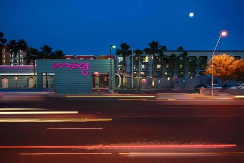 a building with a neon sign on the side of a street at MOXY Phoenix Tempe/ASU Area in Tempe