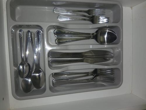 a drawer filled with silver utensils and forks and spoons at Ita Green in Teresópolis