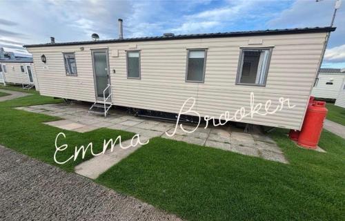 a mobile home with a sign that says emma at Lapwing 17 Cayton Bay in Cayton