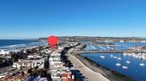 a red balloon flying over a harbor with boats at The Boardwalk Hotel in San Diego