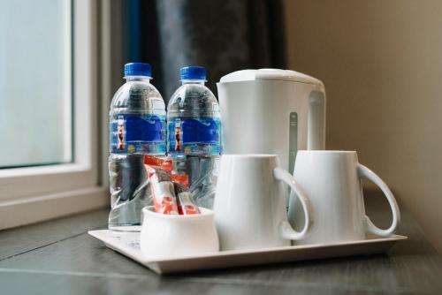 a mixer and two bottles of water on a table at Value Hotel Balestier in Singapore