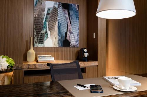 a living room with a table and a lamp at Hotel ICON in Hong Kong