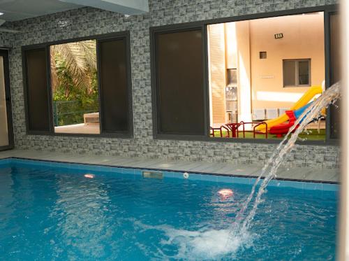 a pool with a water slide in a house at استراحة روضة الوادي - Rawdat Al Wadi House in Nizwa