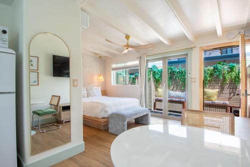 a bedroom with a bed and a table in a room at The Boardwalk Hotel in San Diego