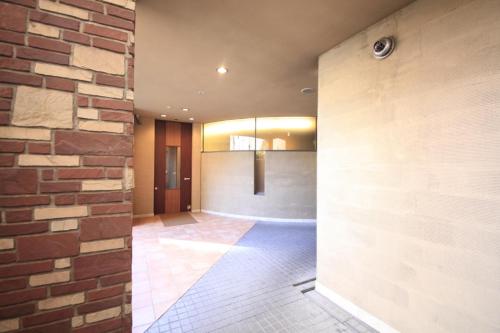 Habitación con pared de ladrillo y pasillo. en R&B Hotel Morioka Ekimae, en Morioka