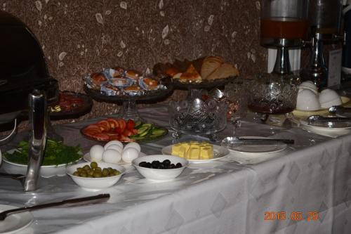 a table with plates of food and bowls of food at Firuz Hotel in Khujand