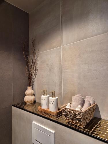 a bathroom with towels and candles on a shelf at Villa The high end of Lofoten- with SAUNA in Moskenes