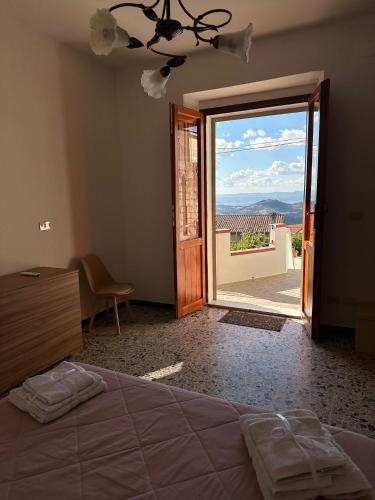 a bedroom with a bed and a sliding glass door at S Istentu in Sarule