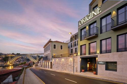 a building with a bridge in the background at Origine Porto Gaia, a Tribute Portfolio Hotel in Vila Nova de Gaia
