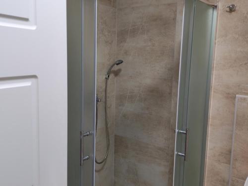 a shower with a glass door in a bathroom at Lacky-ca in Prokuplje