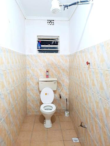 a bathroom with a white toilet in a room at Sonnie stays - One Bedroom Apartment in Kitale