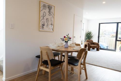 a dining room with a table and chairs at Colour Burst Townhouse in Christchurch