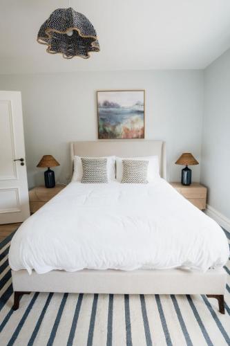 a bedroom with a white bed and two lamps at Balleeghan House in Malin