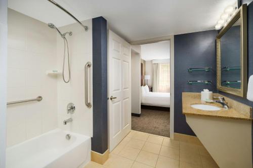 a bathroom with a tub and a sink and a shower at Residence Inn Seattle Northeast/Bothell in Bothell