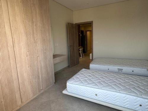 a bedroom with two twin beds and a closet at Mozaik Condotel in Cairo