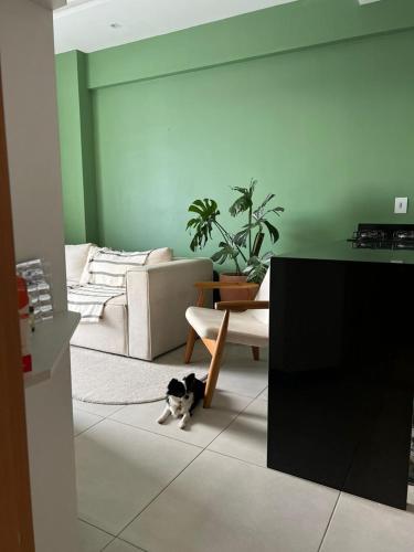 a cat sitting on the floor in a living room at Complet apartment with air conditioning in Belém