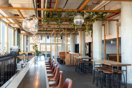 a large room with tables and chairs and windows at Hotel Indigo Lower East Side New York by IHG in New York