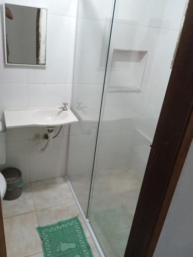 a bathroom with a shower and a sink at Light House Pousada in Paraty