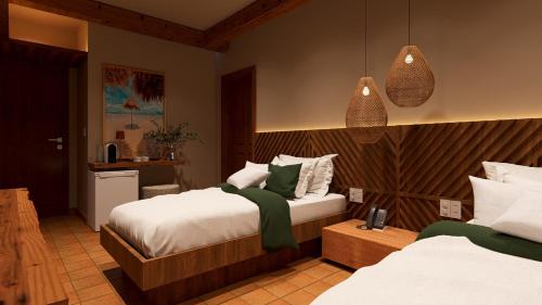 a hotel room with two beds and a kitchen at Hotel Ilha do Marajó by Unna in Soure