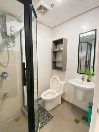 a bathroom with a toilet and a sink at Lovely CondoStay Cebu T2-25 in Cebu City