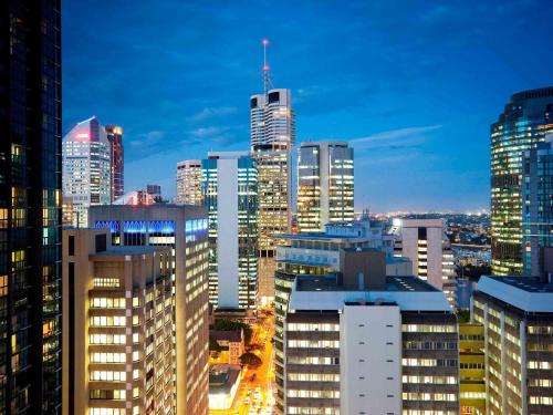 a city skyline at night with tall buildings at The Sebel Brisbane in Brisbane