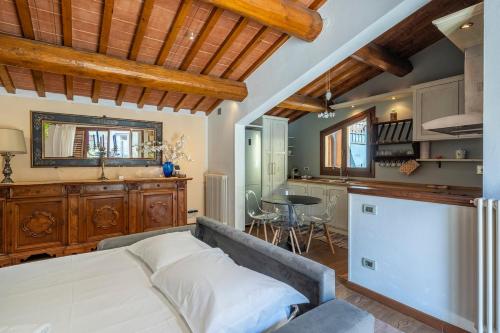 a bedroom with a bed and a kitchen with a table at Small Villa with parking in Florence