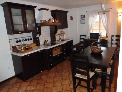 a kitchen with a table and a dining room at Apartment Bohinjčan in Bohinj