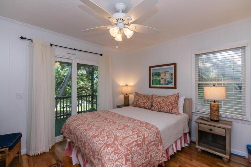 a bedroom with a bed and a ceiling fan at Miss Irene in Edisto Island