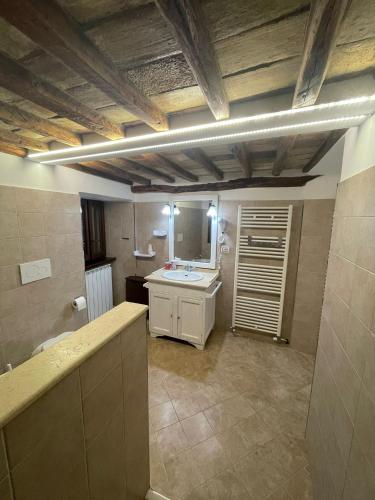 a large bathroom with a sink and a mirror at Borgo Vico in Fiordimonte