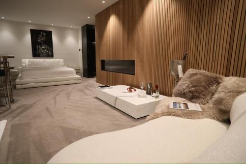 a large living room with a couch and a tv at Amarè Beachside Luxury in Turners Beach