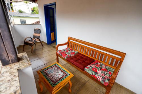 a living room with a couch and a chair at Villa Jardineira in Ouro Preto