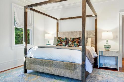 a bedroom with a canopy bed and a window at 3 W Perry St in Savannah