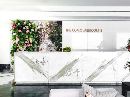 a store front with a marble counter and flowers at The Como Melbourne in Melbourne