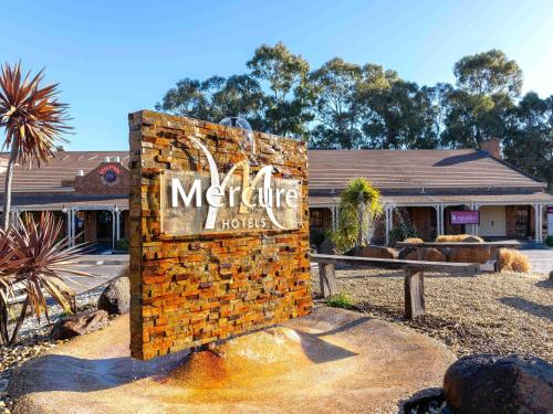 a sign for a motel in front of a building at Mercure Port of Echuca in Echuca