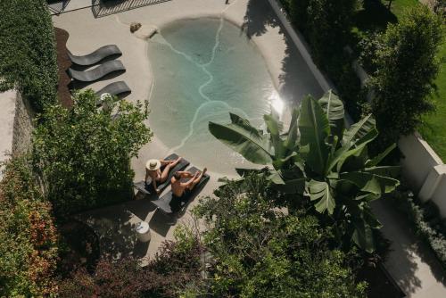 an overhead view of two people in a swimming pool at Sercotel El Balcón de la Bahía Suites in Santander