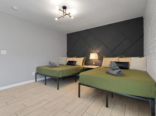 two green beds in a room with a ceiling at Mirage Apartments in Phoenix