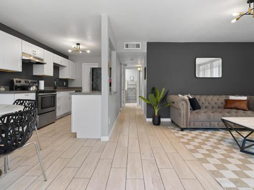 a kitchen and living room with a couch and a table at Mirage Apartments in Phoenix