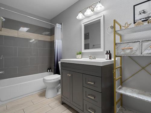 a bathroom with a sink and a toilet and a tub at Mirage Apartments in Phoenix