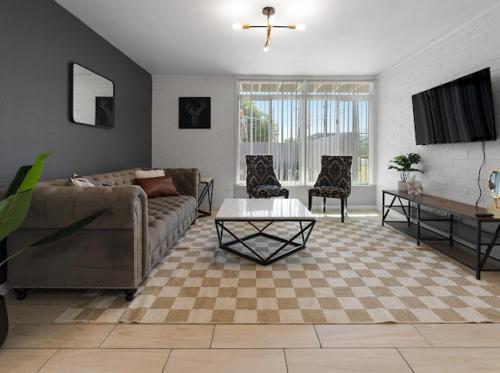 a living room with a couch and a table at Mirage Apartments in Phoenix