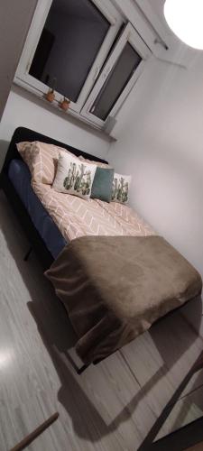 a bedroom with a bed with a blanket on it at Apartament Ziemia Kłodzka in Kłodzko