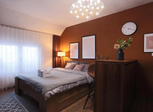 a bedroom with a bed and a clock on the wall at Prime space in Pristina