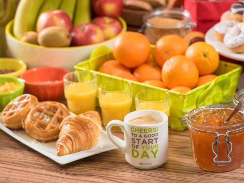 a table with a tray of fruit and a cup of coffee at ibis Styles Meaux Centre in Meaux
