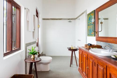 a bathroom with a sink, toilet and tub at Tamarind Hill by Asia Leisure in Galle