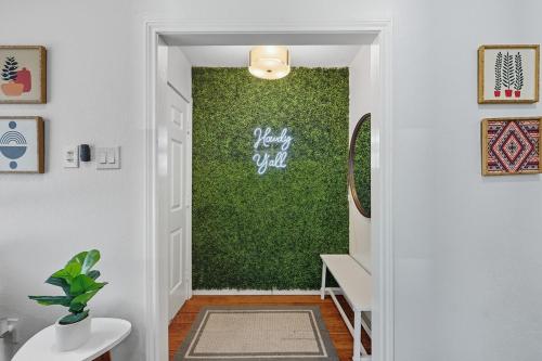 a hallway with a green wall in a house at Vibrant 3BR Dallas Home, Near DFW, With Family-Friendly Amenities in Irving