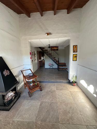 a living room with a fireplace and a staircase at Sierra Chica in Alta Gracia