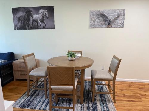 a dining room with a wooden table and chairs at Weehawken Apartment NYC Skyline in Weehawken