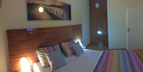 a bedroom with a large bed with a wooden headboard at Vip apartment Beograd in Belgrade