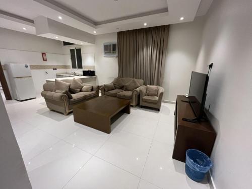a living room with two couches and a tv in it at شقق مفروشه رقميه في العزيزيه in Riyadh